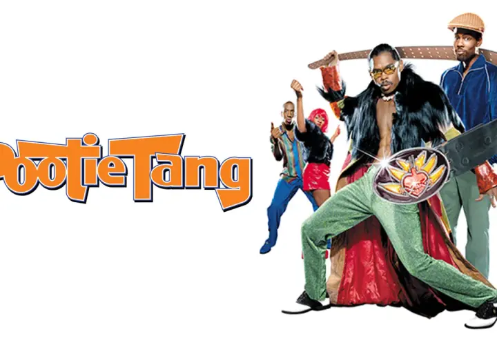 Pootie Tang: Ein Mann mit auffälligem Gürtel und pelziger Weste, umgeben von tanzenden Freunden.