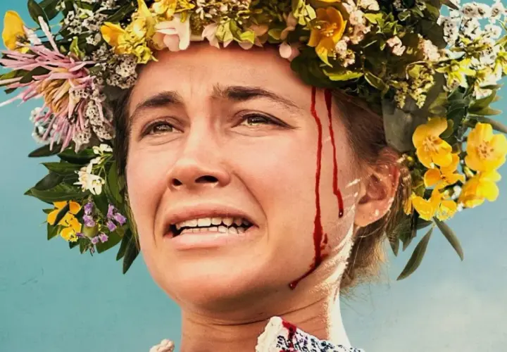 Nahaufnahme einer Frau mit Blumenkranz und Blutspuren im Gesicht. Die besetzung von Midsommar zeigt eine Frau in emotionaler Not.