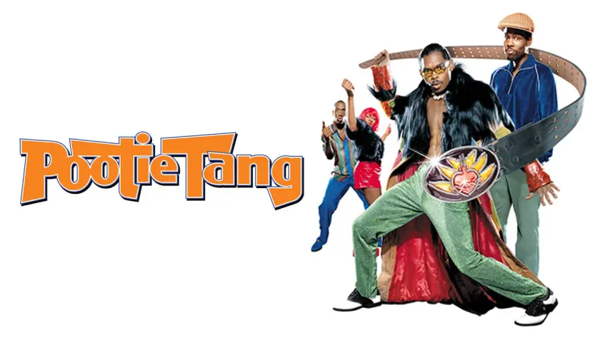 Pootie Tang: Ein Mann mit auffälligem Gürtel und pelziger Weste, umgeben von tanzenden Freunden.