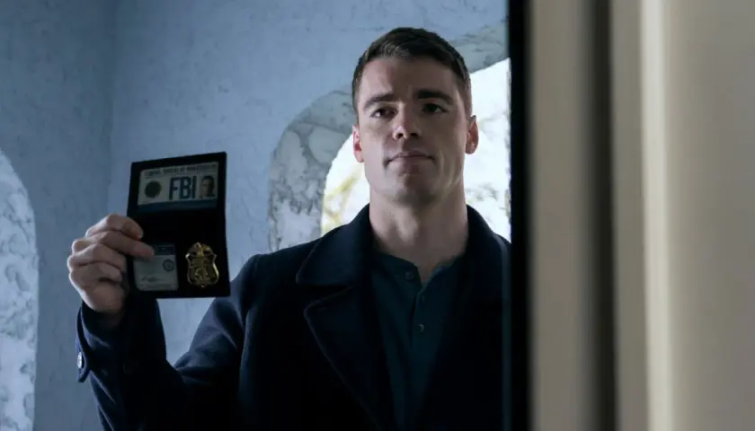 Ein Mann zeigt seinen FBI-Ausweis. Er ist ein Agent aus "Night Agent Staffel 1".