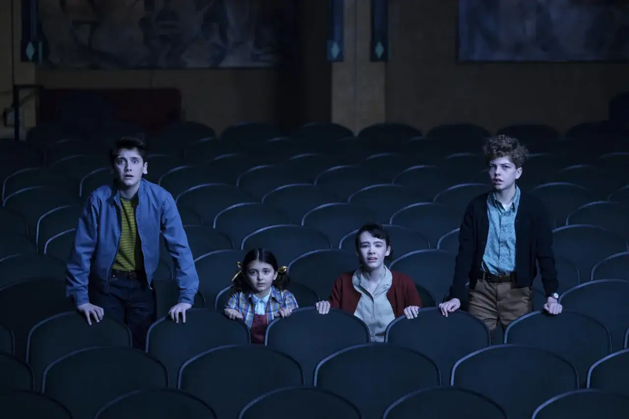 Vier Kinder stehen in einem dunklen Kino, ihre Gesichter voller Schrecken. Willkommen in Derry!